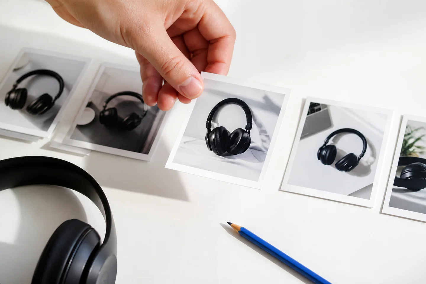 A hand replaces one product-photo frame during an editorial review.