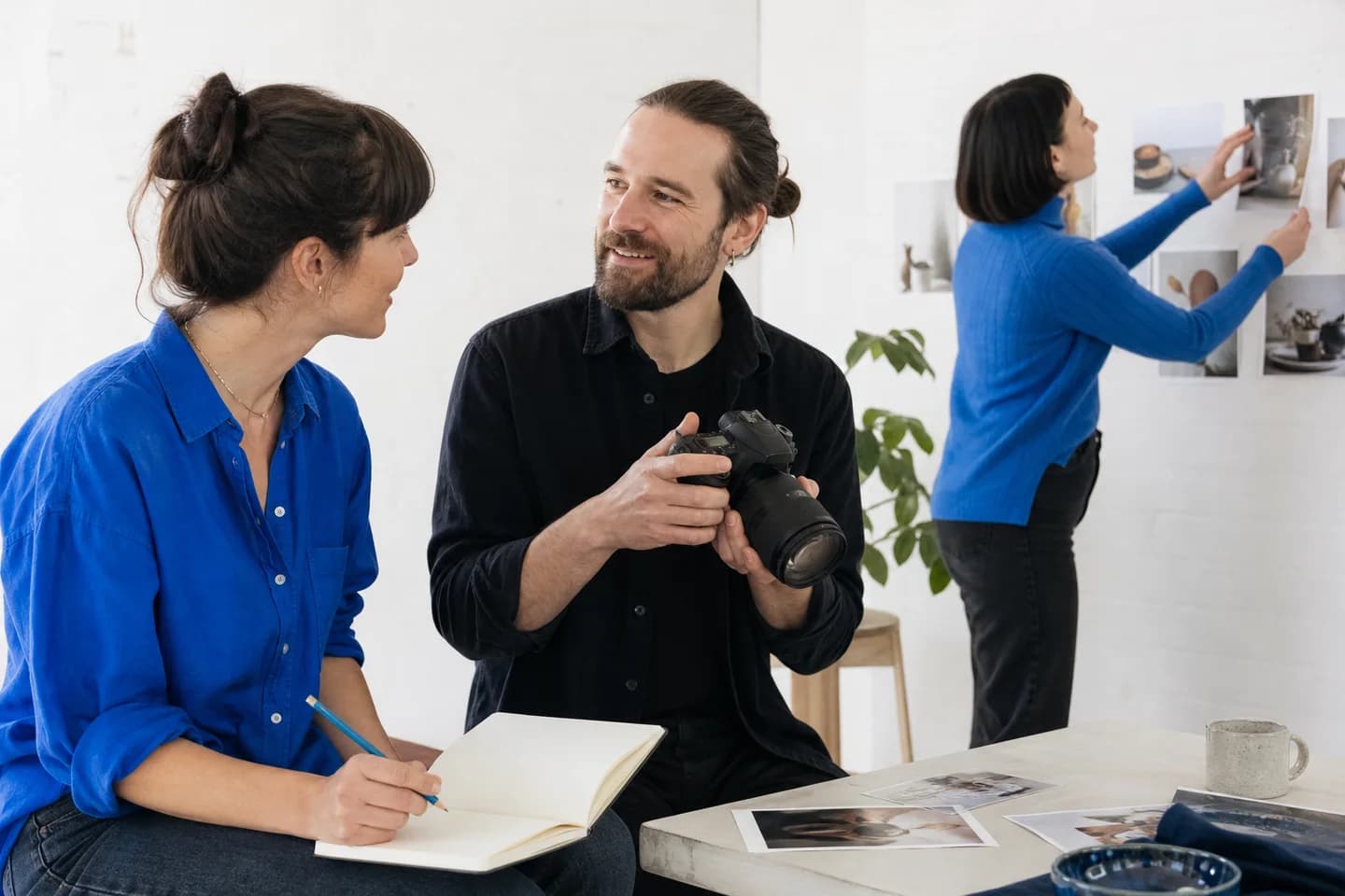 A writer and filmmakers discussing a product story in a bright creative studio.