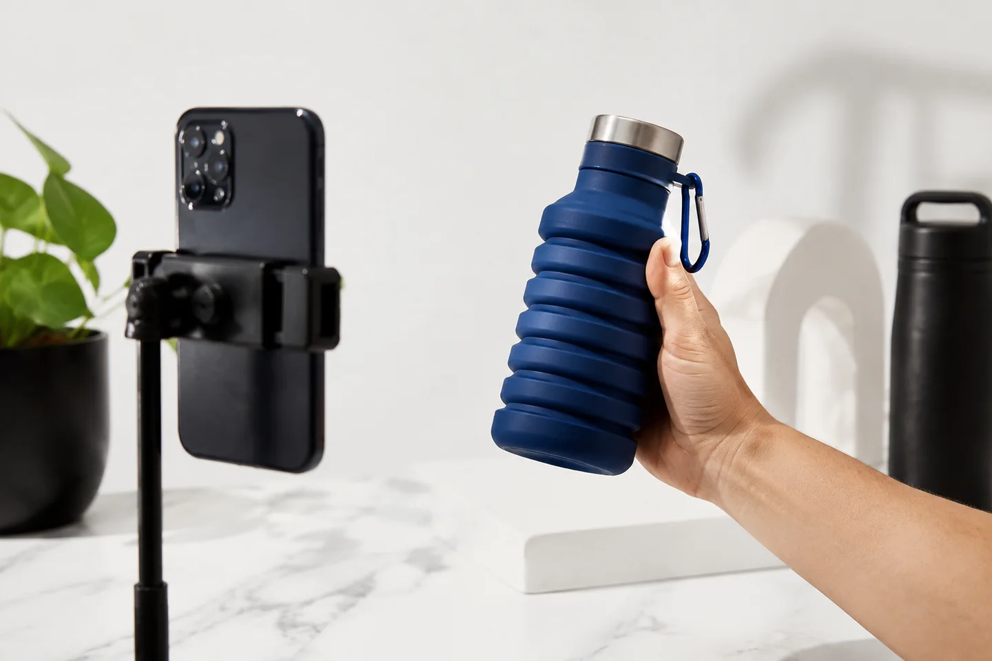 A compact bottle being demonstrated to a vertical phone camera.
