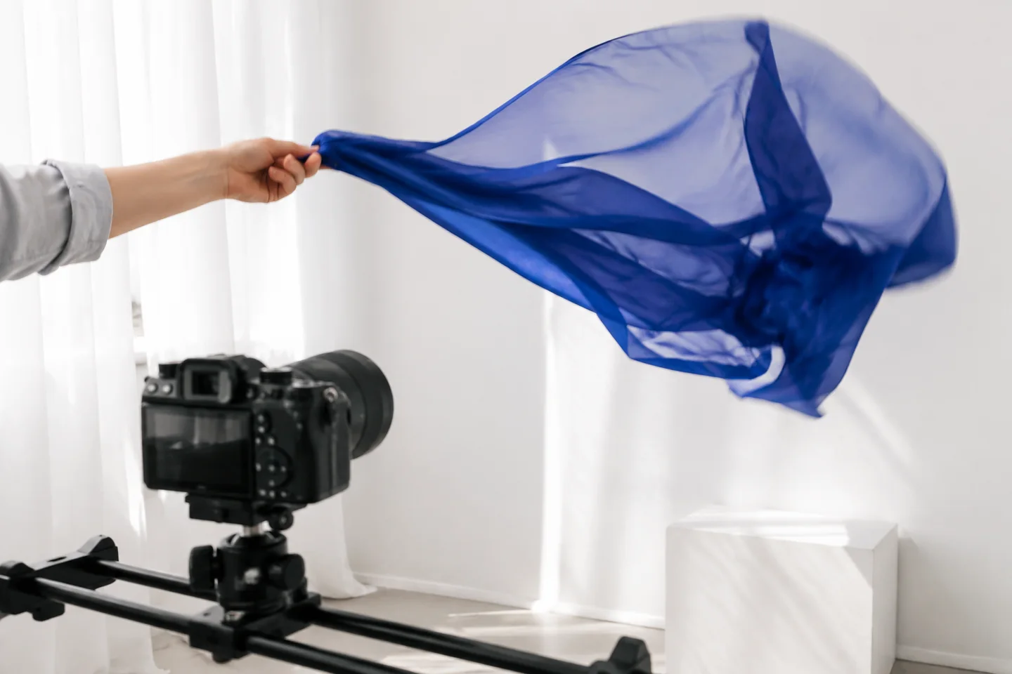 A flowing blue scarf being filmed to test controlled motion.