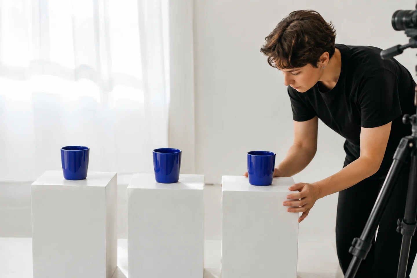 A technician aligning matching studio subjects for a repeatability test.