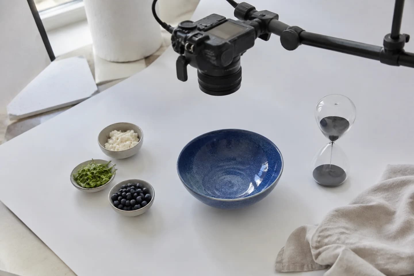 A prepared hands-only recipe filming setup with ingredients and a timer.