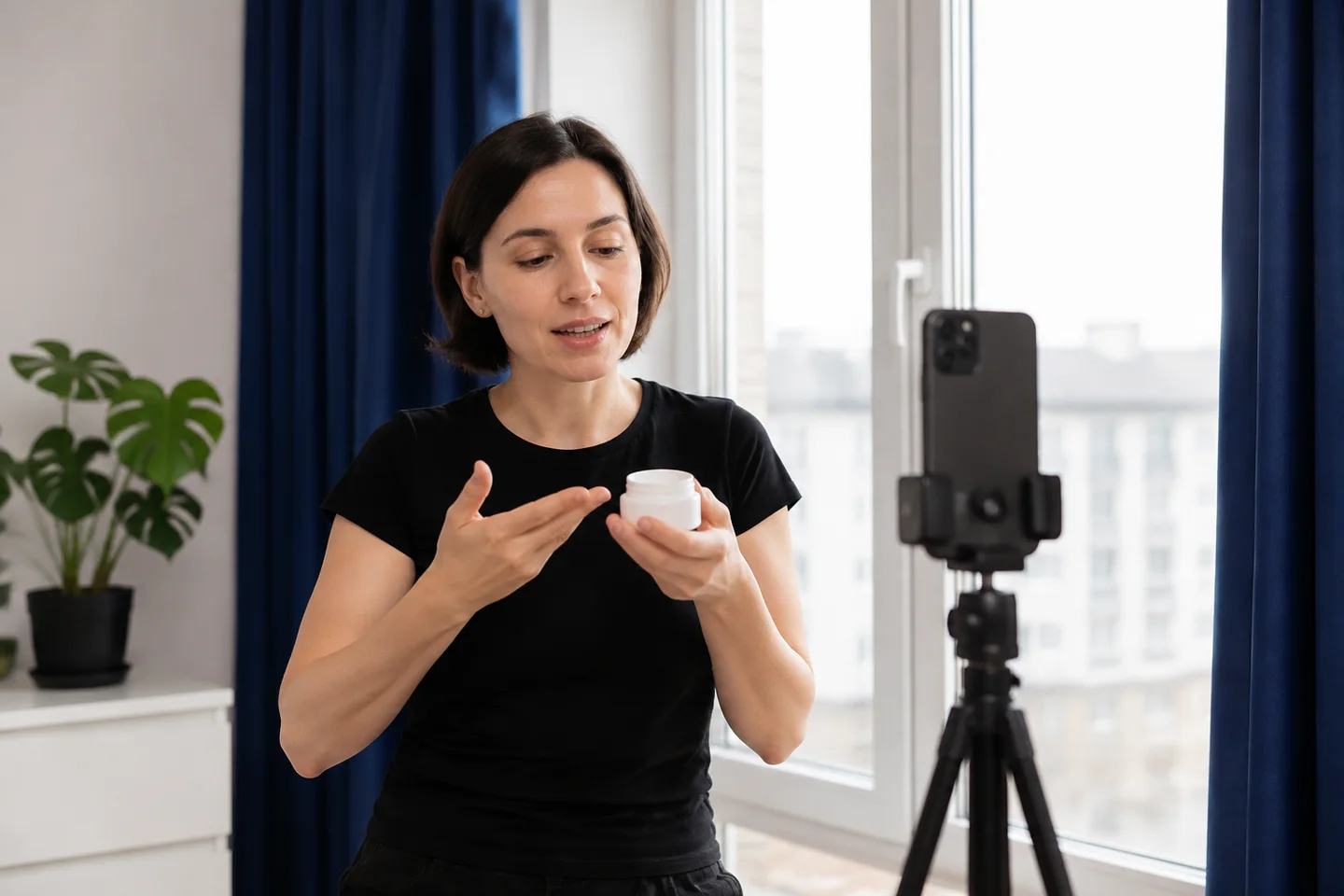 A presenter rehearsing a casual product video beside a window.