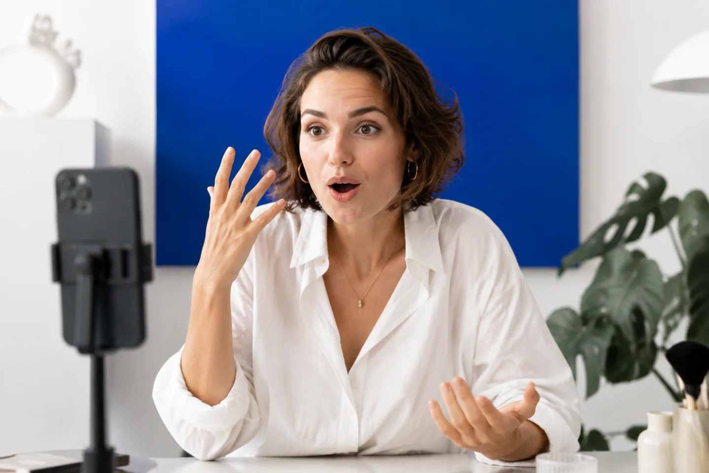 A presenter recording a natural reaction in a bright studio.